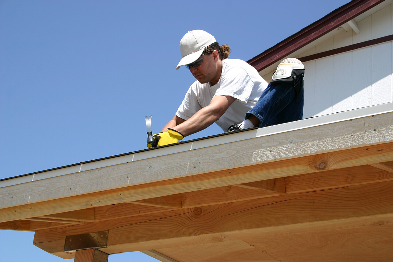 carpenter repairing the roof of a house