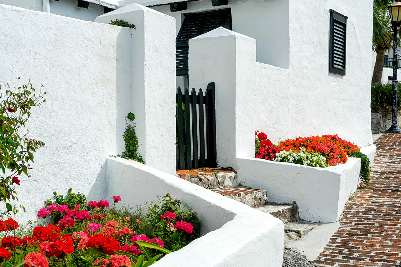 newly repaired stucco home and retaining wall with flowers