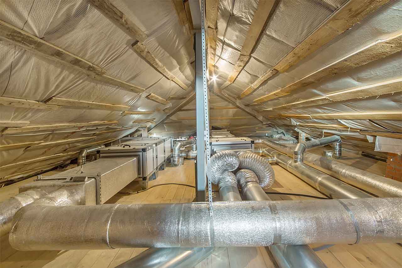 A view of whole house fan pipes in an attic