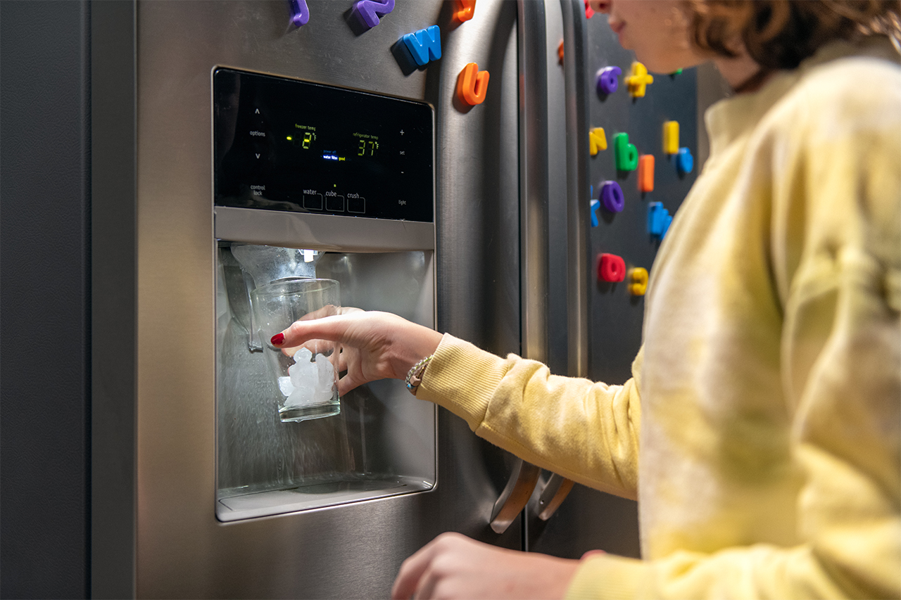 woman getting ice from the fridge