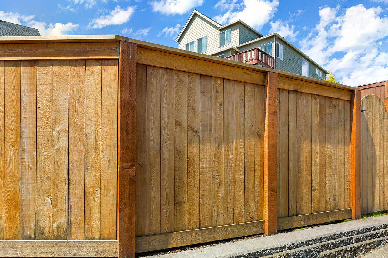 new wooden privacy fence built around backyard